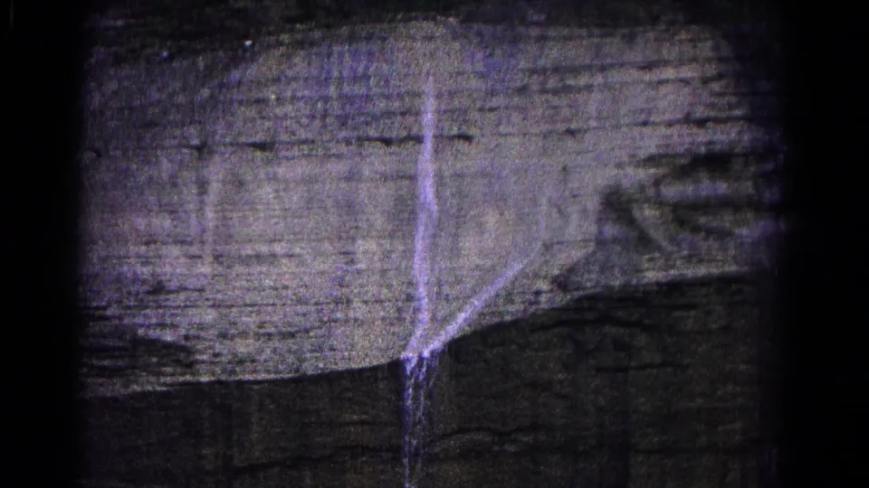 Final 1966 Hagerstown frame showing a pale trickle dropping down layered cliff rock beside a darker recessed area.