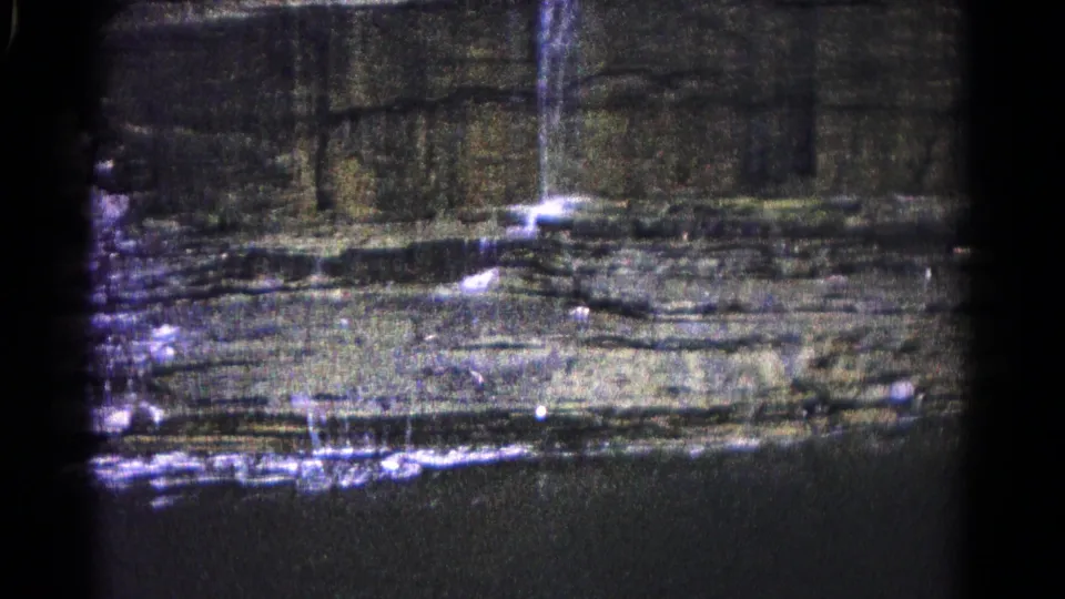 Late frame of the 1966 Hagerstown waterfall shot, with water streaking down the cliff and bright spray over the lower rocks.
