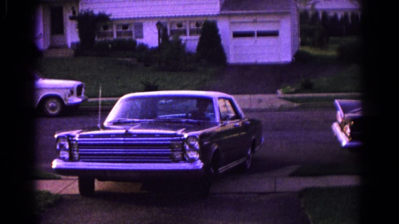 Sedan angled out of a driveway onto a residential street.