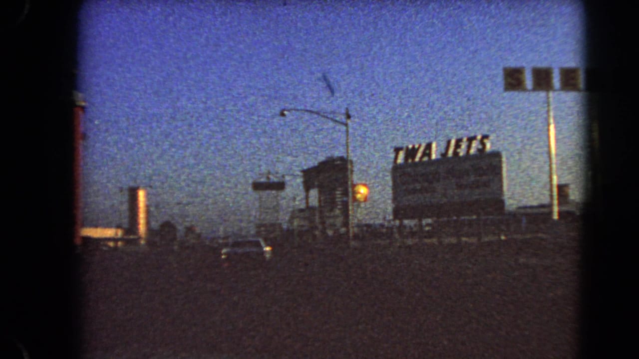 A 1966 Las Vegas street view shows cars approaching roadside signs, including a TWA Jets billboard and Shell gasoline sign.