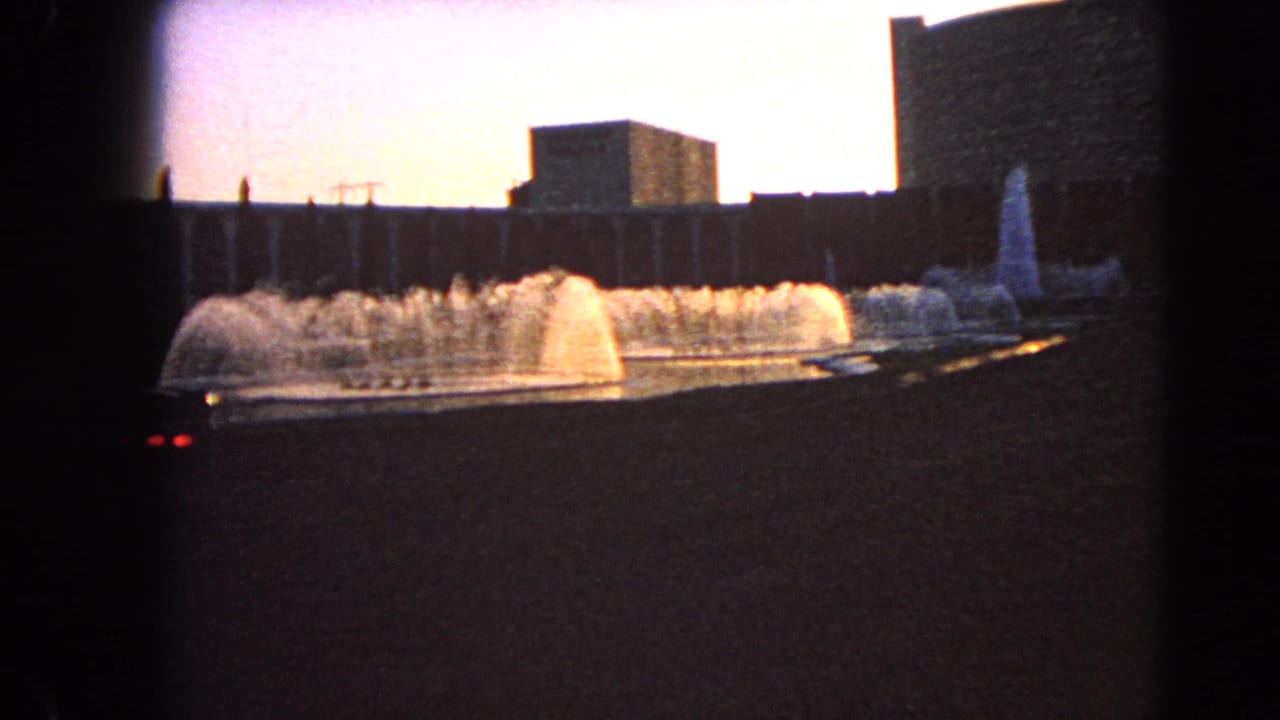 1966 Las Vegas home-movie view of a fountain display with a tall vertical feature near the right edge and dark frame vignetting.