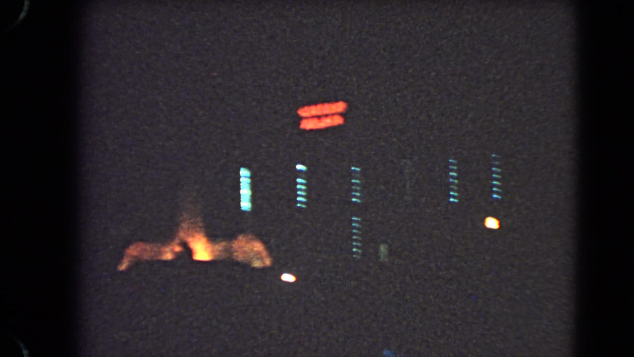 1966 Las Vegas night footage showing red neon signage above dim building lights and an orange glow near the lower street area.