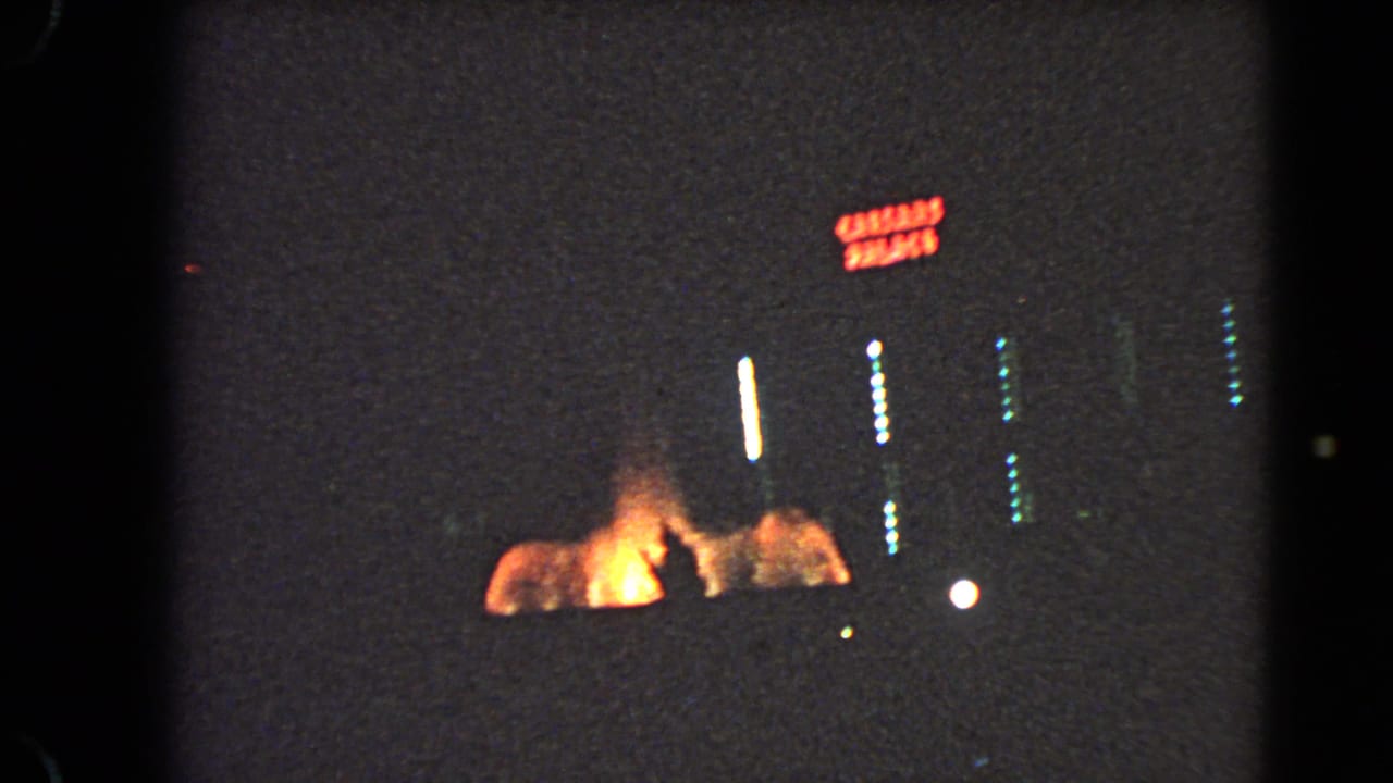 1966 Las Vegas nighttime street view with a red neon sign, bright vertical light streaks, and orange illumination near the ground.