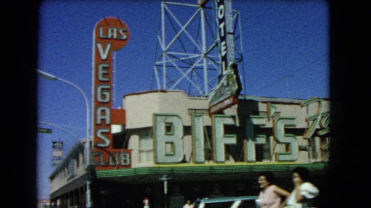 1966 Las Vegas street frame showing Biff's Club, the Las Vegas Club vertical sign, parked or moving cars, and pedestrians.