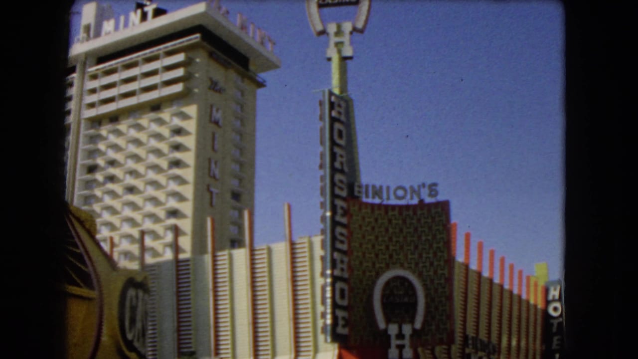 1966 Las Vegas 8mm frame showing The Mint hotel tower, Horseshoe Casino sign, and Binion's facade signage.