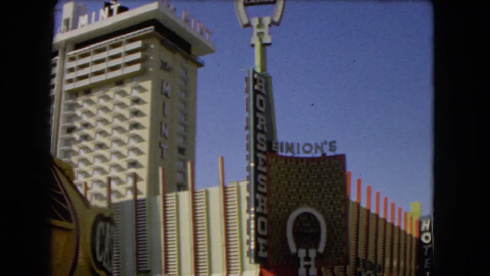 1966 Las Vegas 8mm frame showing The Mint hotel tower, Horseshoe Casino sign, and Binion's facade signage.