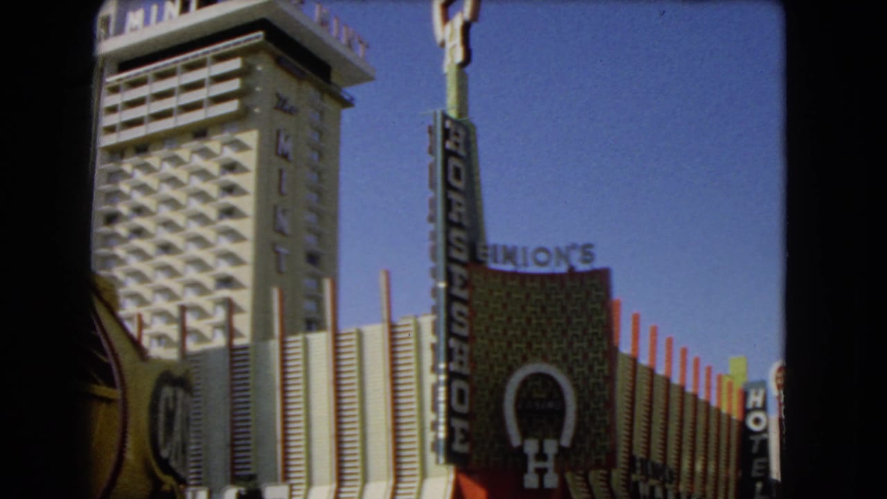 Downtown Las Vegas exterior with The Mint, Horseshoe Casino sign, and Binion's signage visible in a 1966 8mm frame.