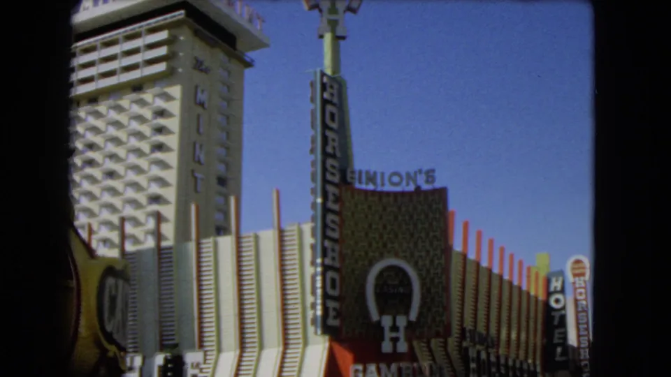 Final 1966 Las Vegas frame showing The Mint, Horseshoe Casino sign, Binion's signage, and surrounding hotel signs.