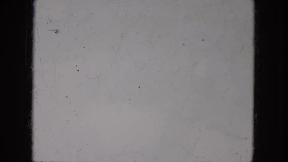 1966 8mm home-movie frame sample from Milwaukee metadata, showing pale exposed film, dark frame edges, dust, scratches, and grain.