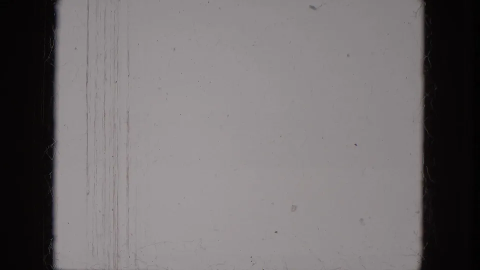 1966 8mm frame sample from Milwaukee metadata showing pale exposure, black border, vertical scratches, dust, grain, and faint smudging.