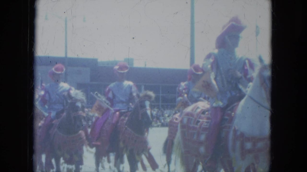 1966 Milwaukee parade footage showing mounted riders in dress-like uniforms moving past spectators on decorated horses.