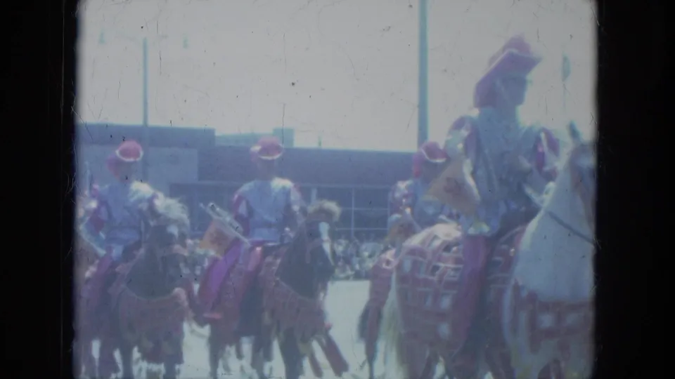 1966 Milwaukee parade footage showing mounted riders in dress-like uniforms moving past spectators on decorated horses.