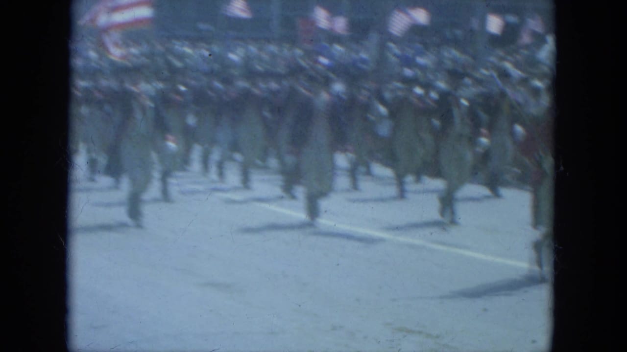 1966 Milwaukee parade view of men in Revolutionary War-style dress marching with spectators and American flags in the background.