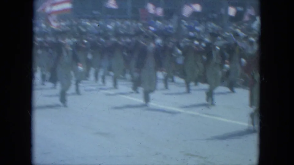 1966 Milwaukee parade view of men in Revolutionary War-style dress marching with spectators and American flags in the background.