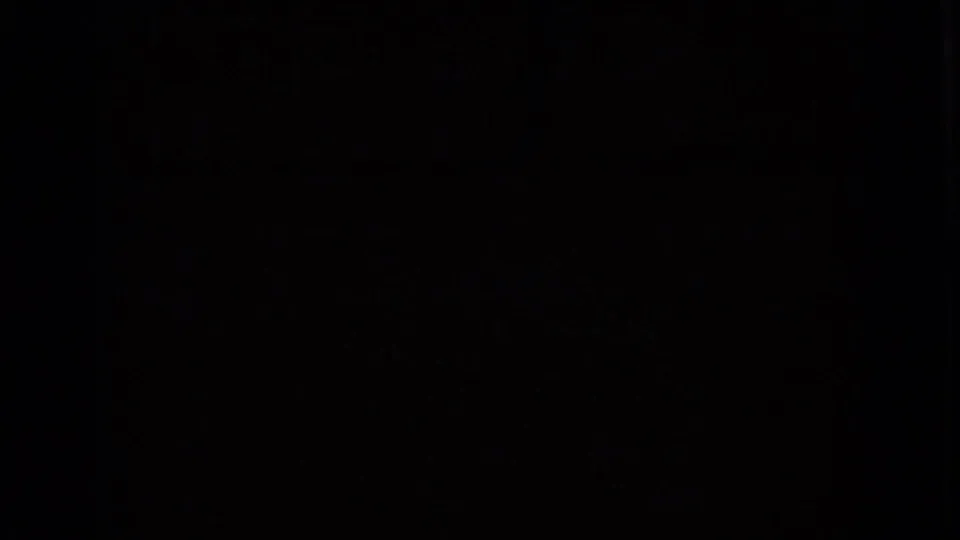 Dark transitional 8mm frame with minimal visible detail, likely between vehicle-shot views in the Nevada road-trip clip.