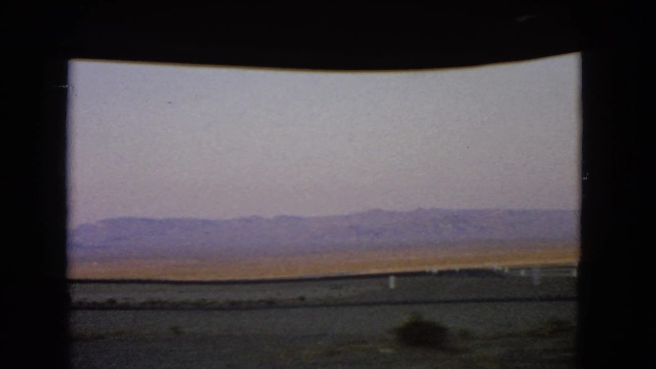 The 1966 Nevada travel view ends on desert foreground, sparse brush, and mountains under a pale sky.