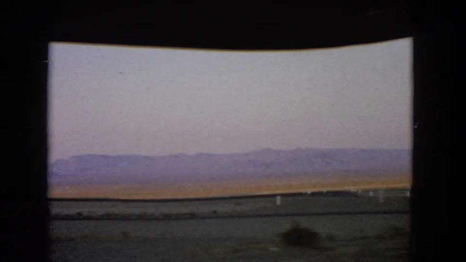 The 1966 Nevada travel view ends on desert foreground, sparse brush, and mountains under a pale sky.