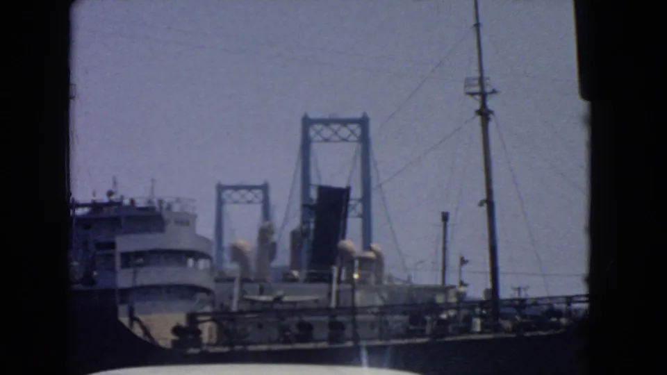 1966 San Pedro harbor shot with the ship lower in frame and the raised drawbridge centered beyond it.
