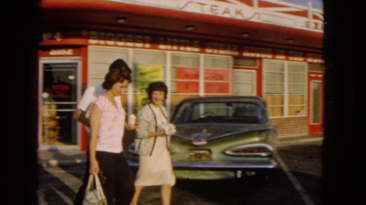 The final frame shows two women close to camera outside the San Pedro steak house, with the vintage car and storefront behind them.