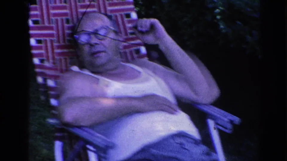 In 1966 Silver Lake home-movie footage, a man in glasses and a white tank top rests in a red-and-white woven lawn chair.