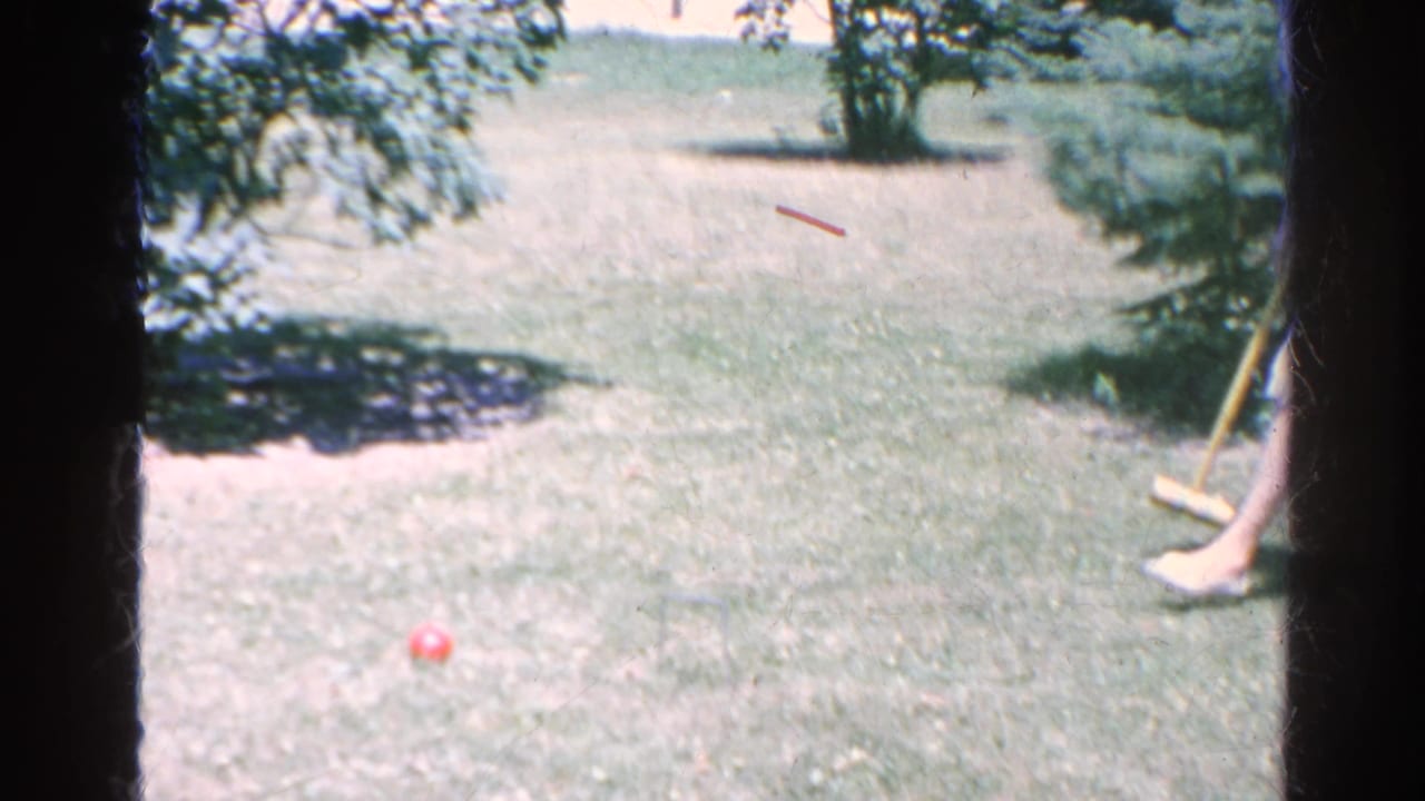 The Silver Lake backyard lawn shows a red croquet ball on the grass with wooden mallets partly visible at the right edge.