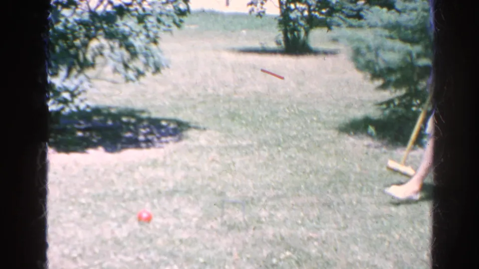 The Silver Lake backyard lawn shows a red croquet ball on the grass with wooden mallets partly visible at the right edge.