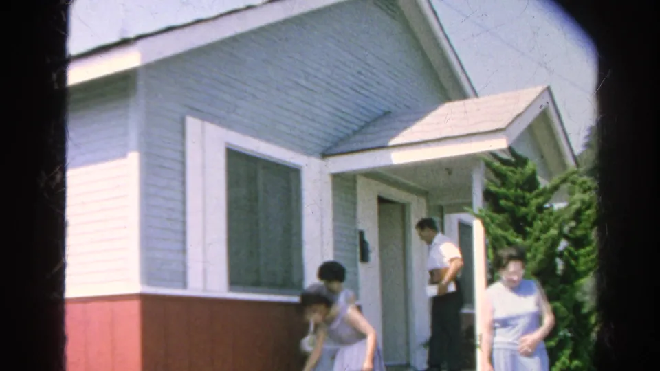 A man in a white shirt stands near the doorway while the women continue leaving the Silver Lake residence.