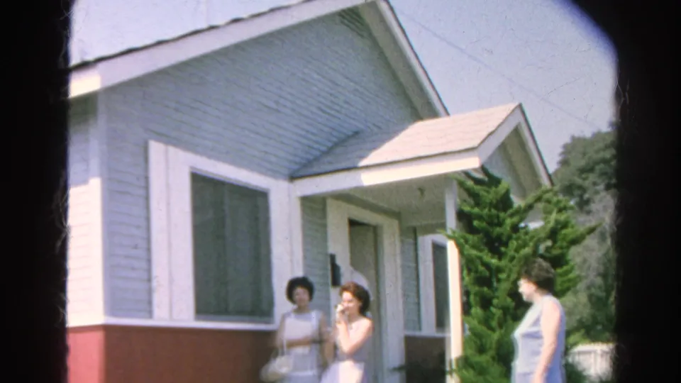 Women pause near the open doorway of the Silver Lake house, with a man partly visible behind them.