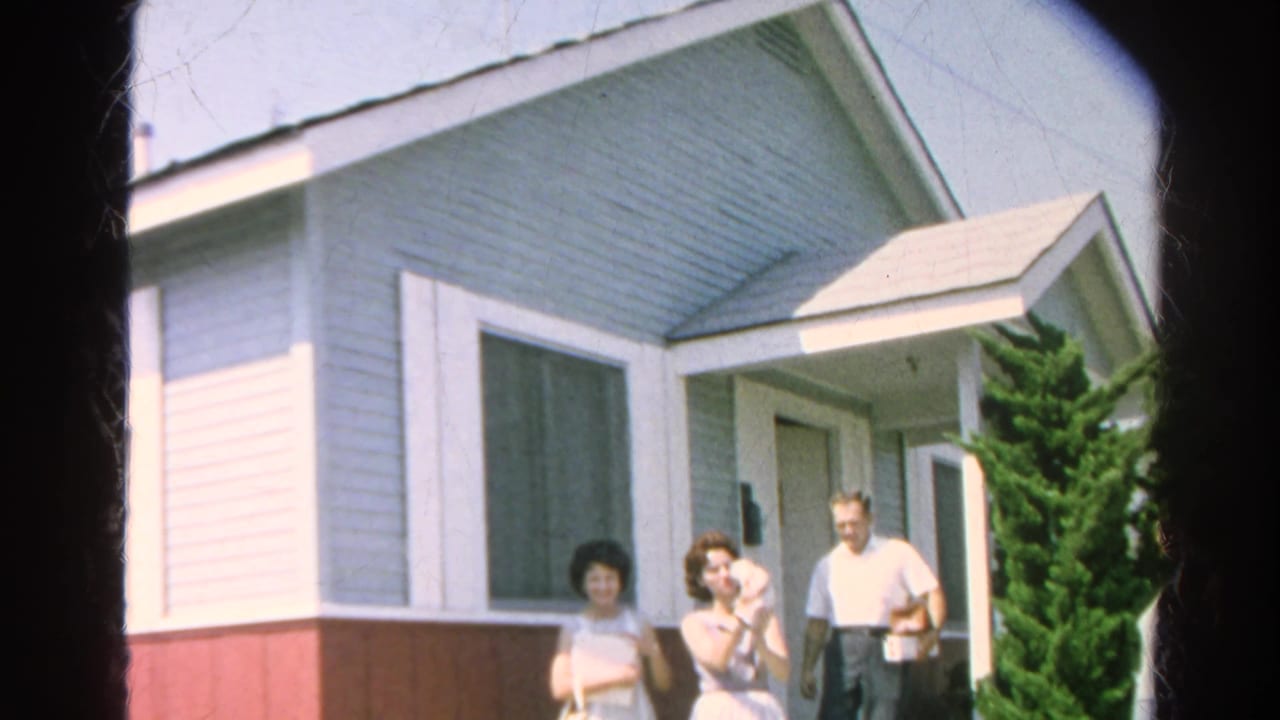 In 1966 Silver Lake, four adults gather outside a light blue residence, with one woman holding a cat near the open front door.