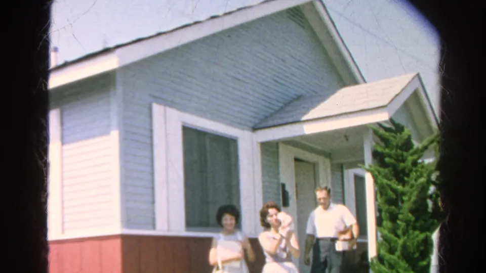 In 1966 Silver Lake, four adults gather outside a light blue residence, with one woman holding a cat near the open front door.