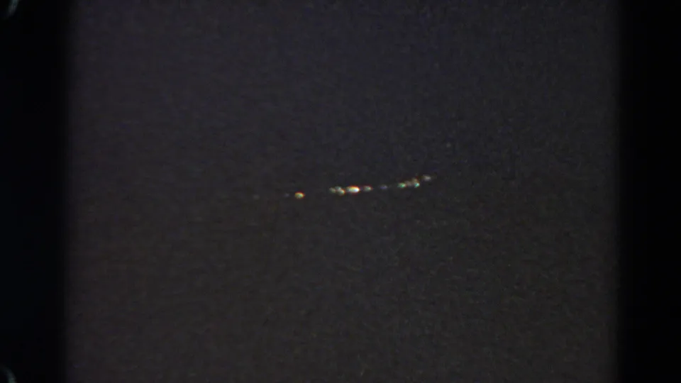 Low-light 8mm view from Silver Lake, California, showing small distant lights in a dark outdoor setting.