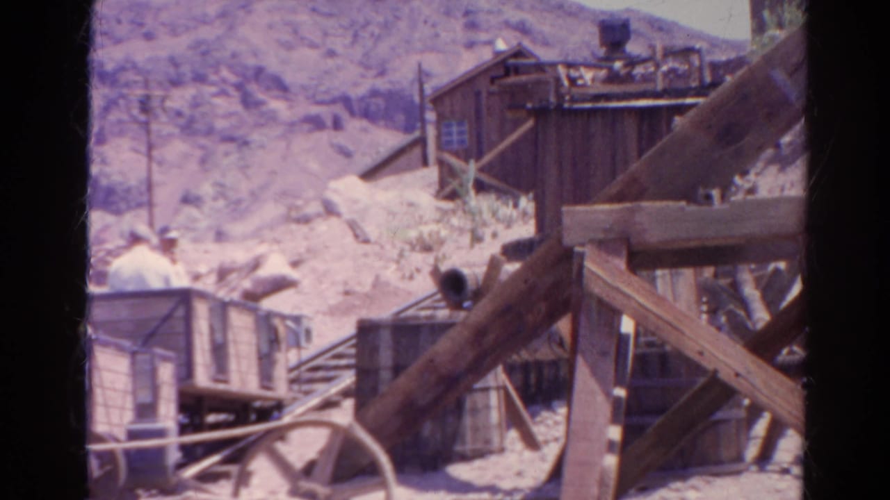 1966 Silver Lake, California home-movie frame showing a mining-themed ride structure, rails, timber beams, and rocky hills.