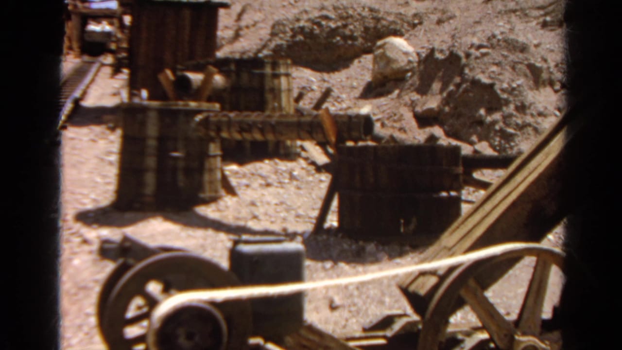 Silver Lake, California mining-site detail with barrels, rails, rocky terrain, and wood equipment captured on 8mm film in 1966.