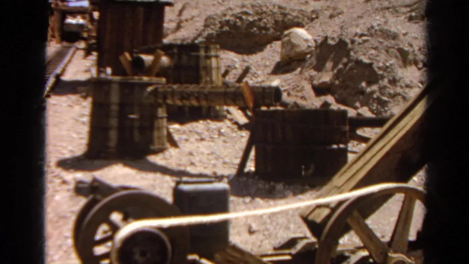 Silver Lake, California mining-site detail with barrels, rails, rocky terrain, and wood equipment captured on 8mm film in 1966.