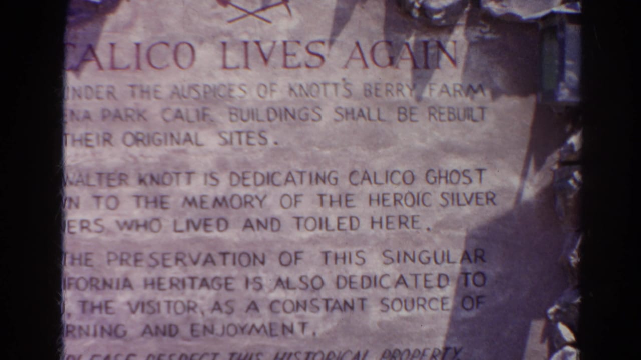 1966 close-up of the Calico Lives Again sign, showing faded lettering about preservation, rebuilding, and visitor learning.