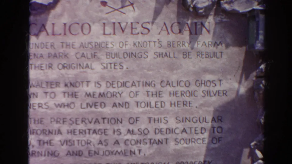 1966 8mm close-up of a weathered commemorative inscription with Calico Lives Again text and partial dedication wording.