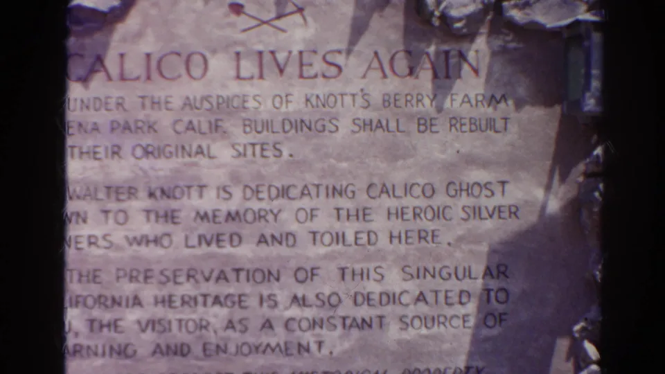 1966 8mm frame showing the Calico Lives Again inscription, with Knott's Berry Farm wording partly readable through grain and shadow.