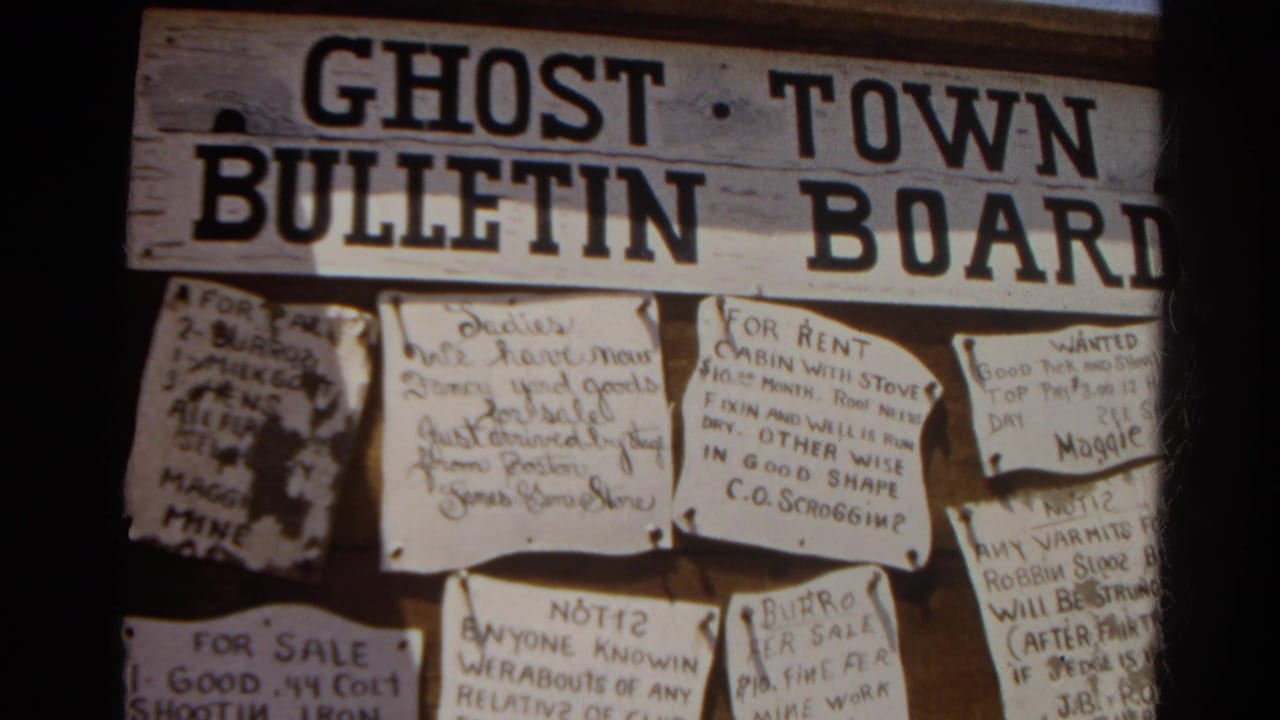 1966 8mm frame from Silver Lake, California, showing a weathered Ghost Town Bulletin Board with multiple pinned handwritten notices.