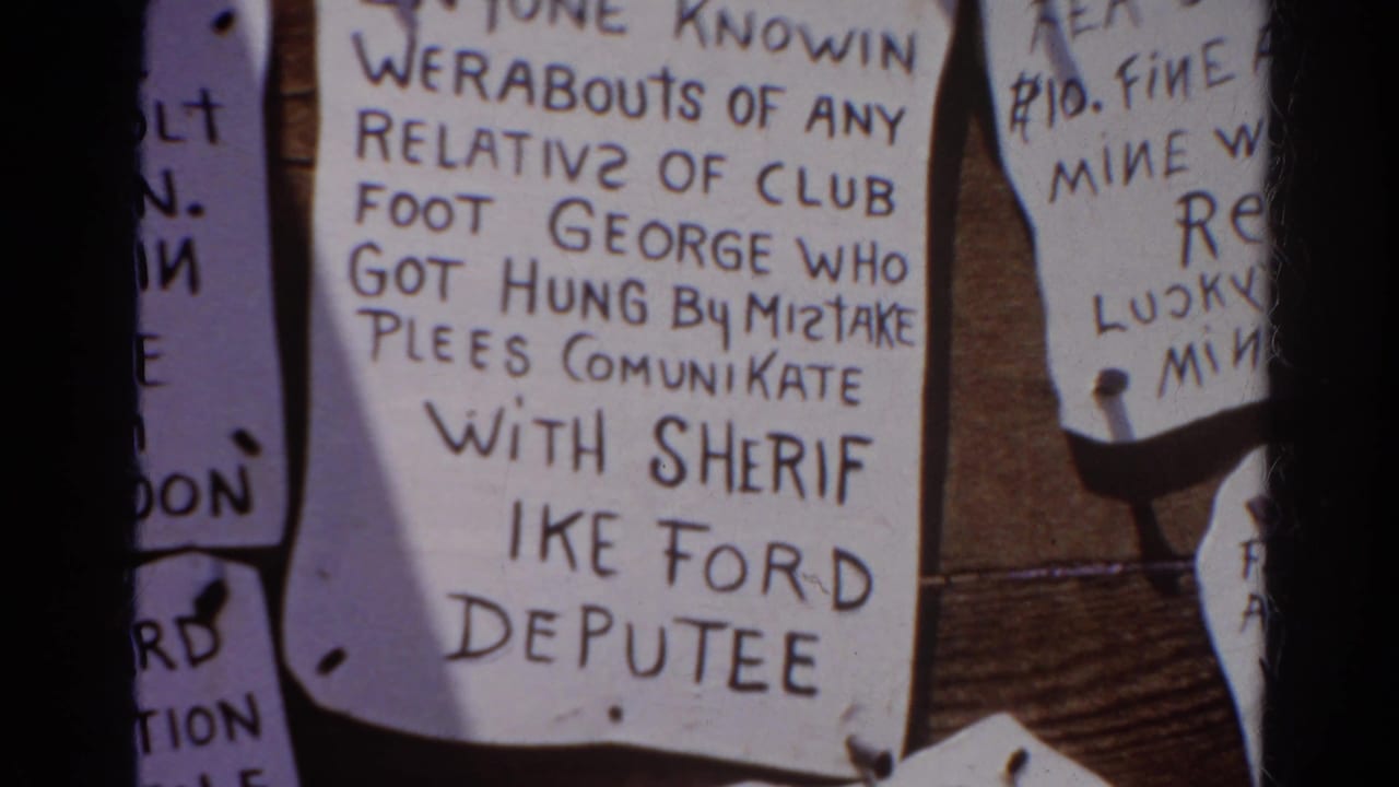 1966 Silver Lake 8mm frame showing handwritten notices on a wooden board, including text about Club Foot George and Sheriff Ike Ford.
