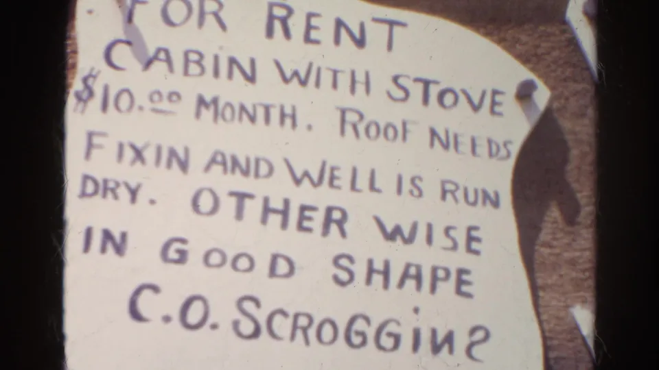 Close 1966 Silver Lake frame of a pinned rental notice describing a cabin, a dry well, needed roof repairs, and contact name.
