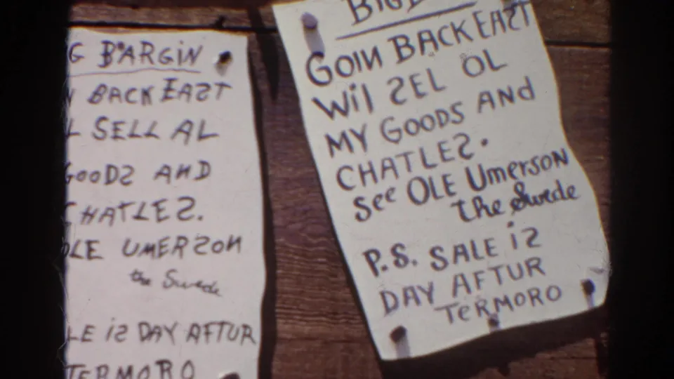Silver Lake 1966 home-movie frame with a pinned handwritten Big Bargain notice on wood.