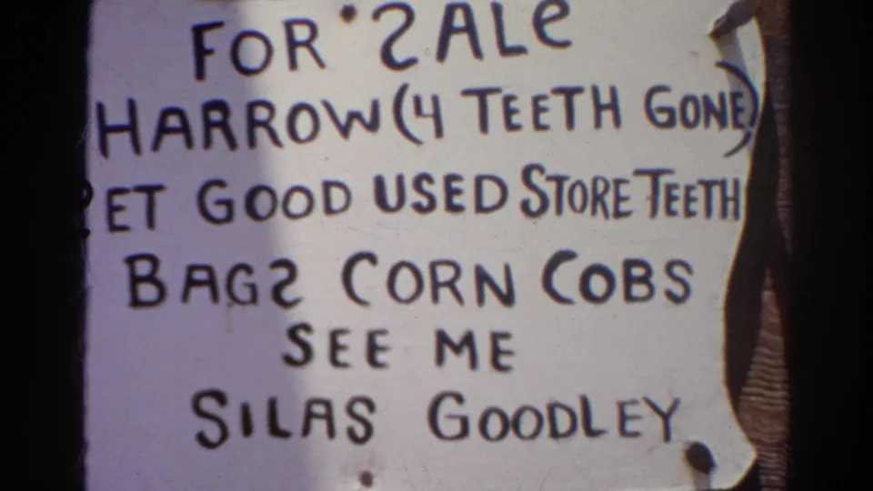 1966 Silver Lake 8mm frame showing a close handwritten for-sale sign with spelling errors, pinned paper, dark lettering, and the name Silas Goodley.