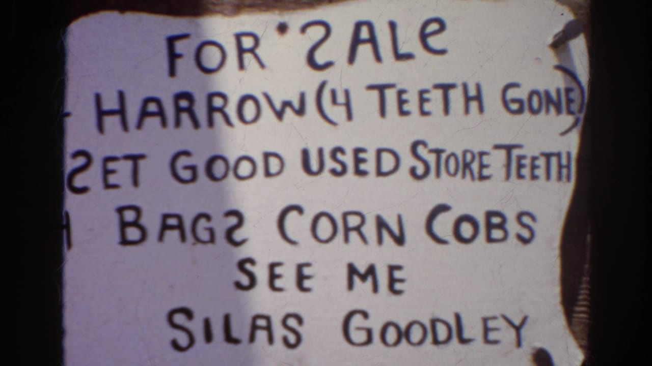 Second close view of the same handwritten sale sign listing a harrow, used store teeth, corn cobs, and Silas Goodley.