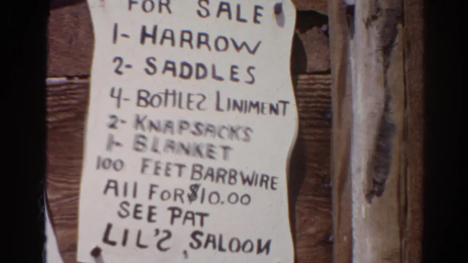 1966 Silver Lake 8mm frame showing a handwritten sale list on a wooden wall, with goods priced together for $10.00 and a reference to Pat's Lil' 2 Saloon.