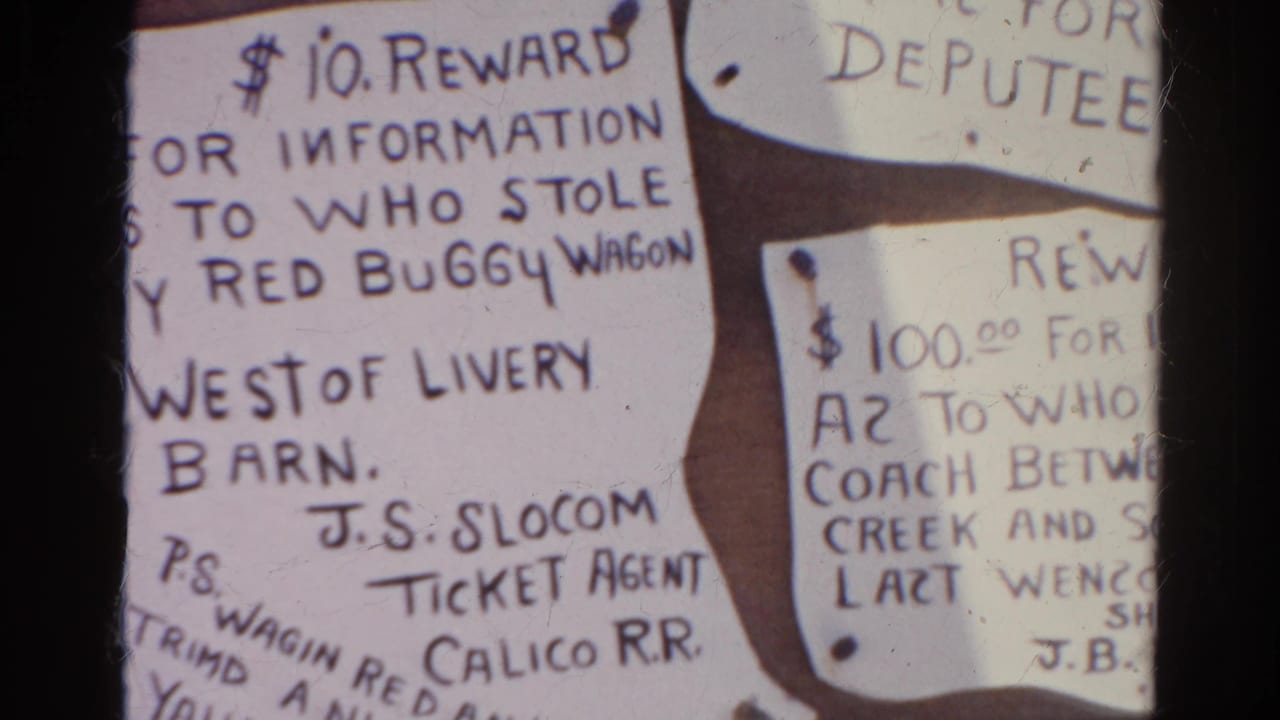 1966 8mm frame from Silver Lake, California, showing handwritten reward notices, including one about a stolen red buggy wagon.
