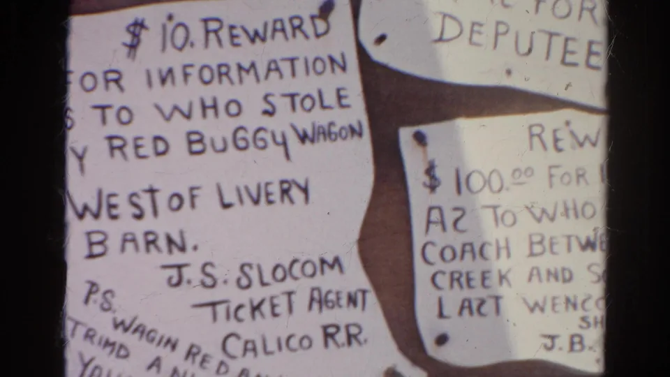 1966 8mm frame from Silver Lake, California, showing handwritten reward notices, including one about a stolen red buggy wagon.