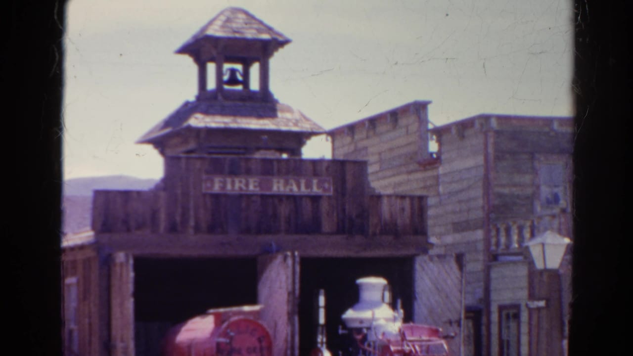 Western-style fire hall with a small bell tower and open garage.