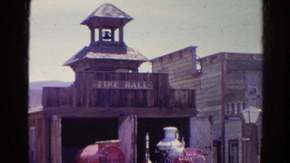 1966 Silver Lake footage showing a wooden Western-style fire hall facade with a small bell tower and a red fire engine inside the open bay.