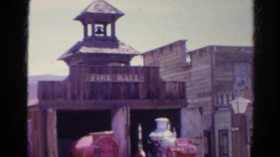 Final 1966 Silver Lake frame shows the Western-style fire hall, bell tower, open garage, red fire engine, and adjacent weathered storefront set.
