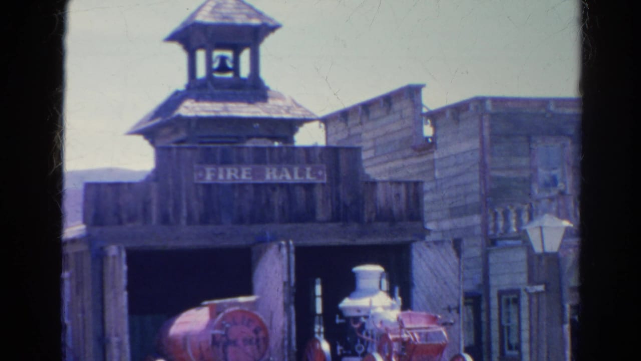 1966 Silver Lake view of the FIRE HALL sign, wooden bell tower, street lamp, and red steam fire engine below the facade.